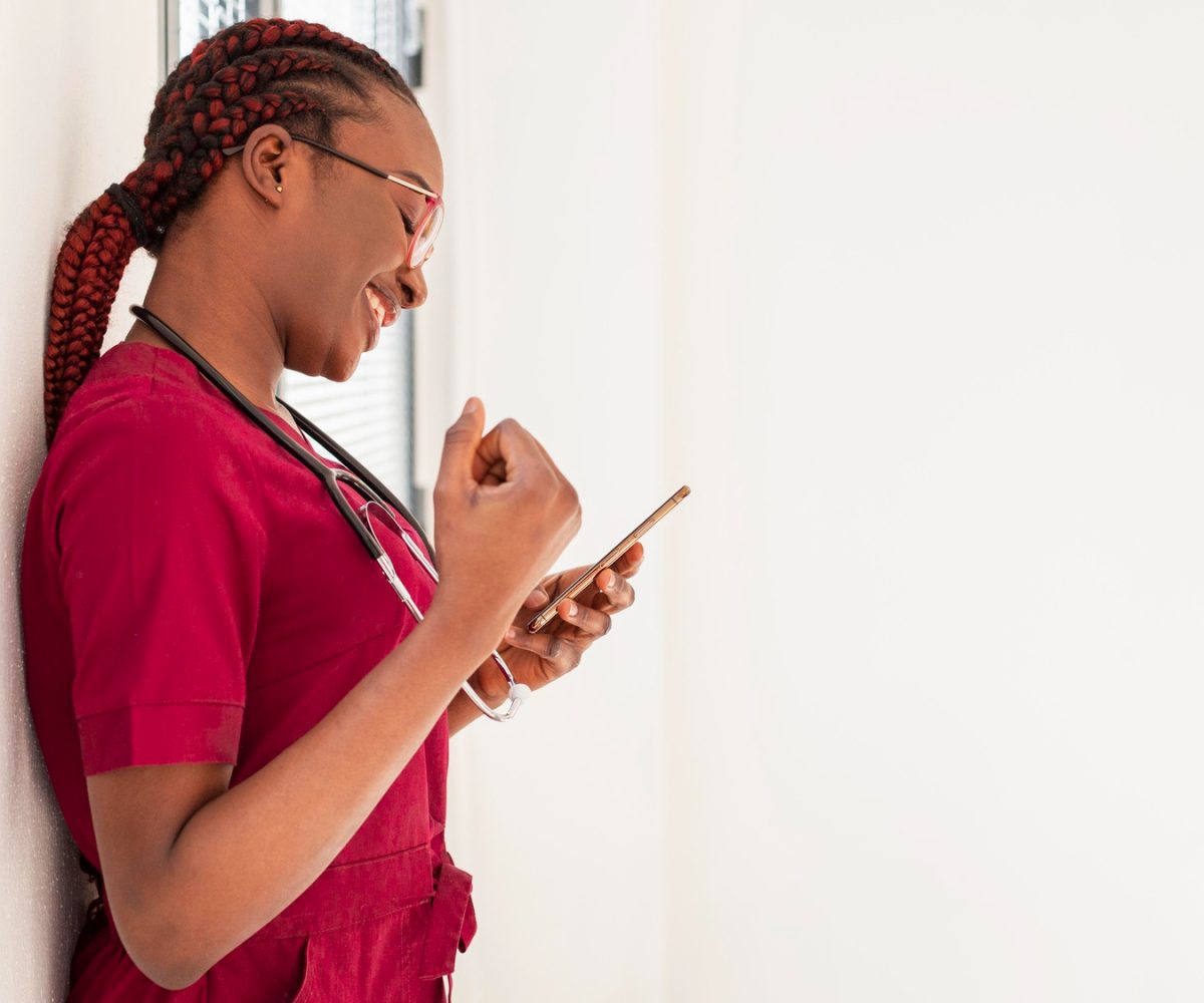 woman-medic-smiling-her-phone